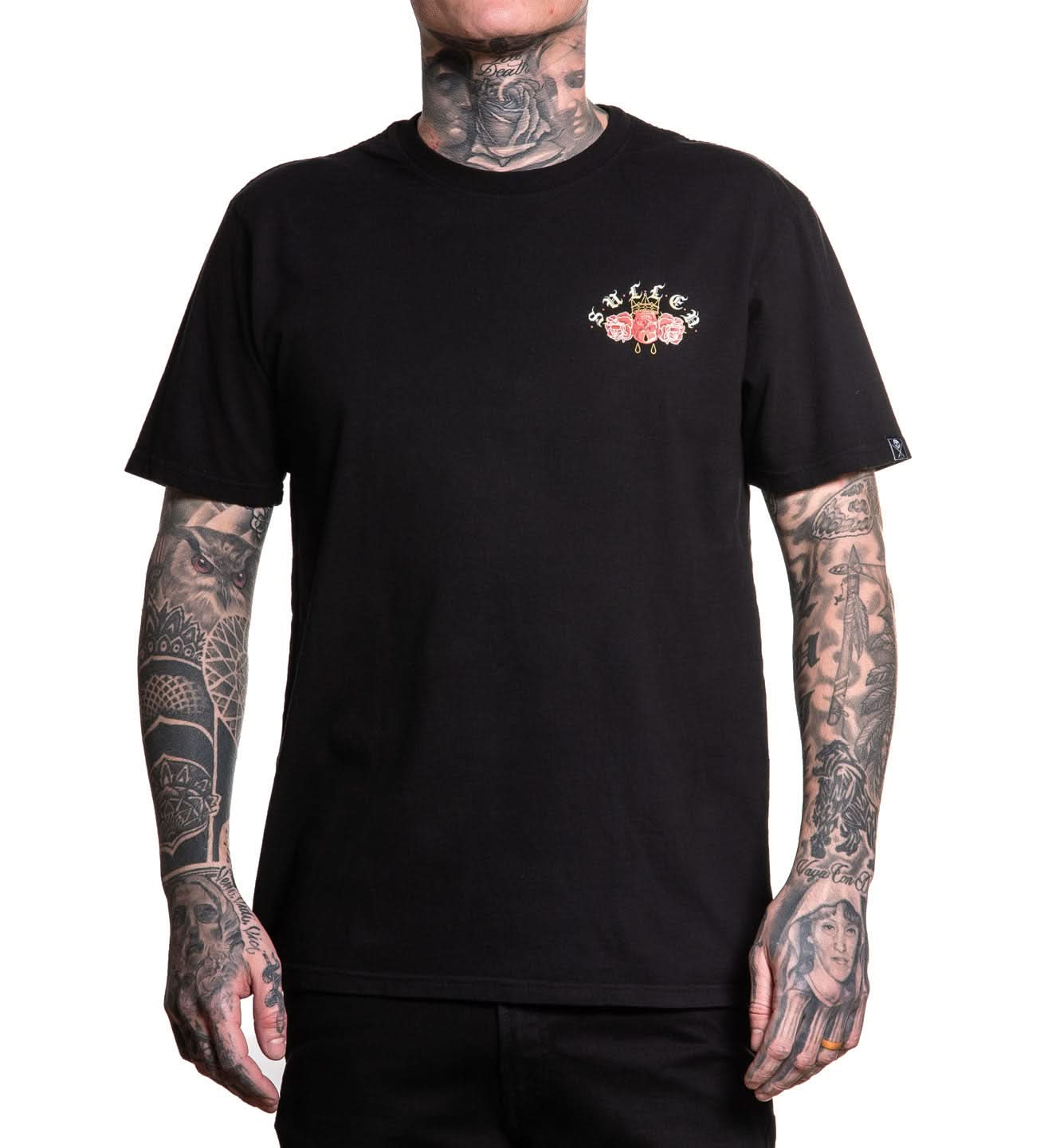 Person wearing a black t-shirt with a floral logo on a white background