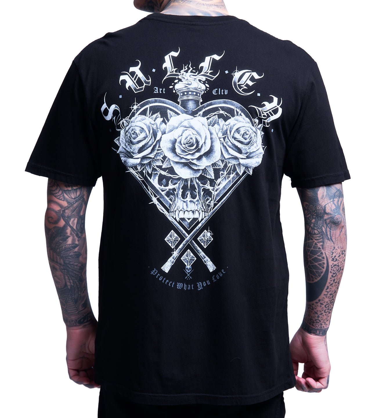 Black t-shirt with white graphic design on the back, featuring roses and a skull, worn by a person.