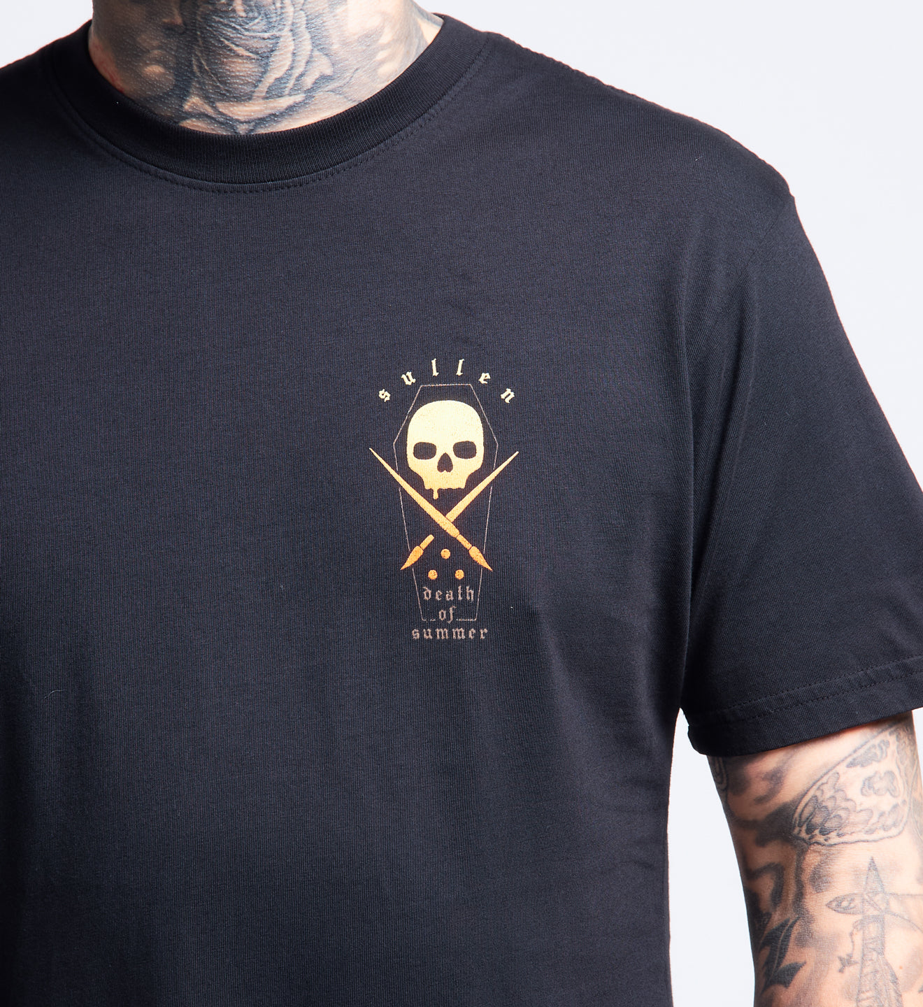Black t-shirt with a skull and crossbones design on a plain background