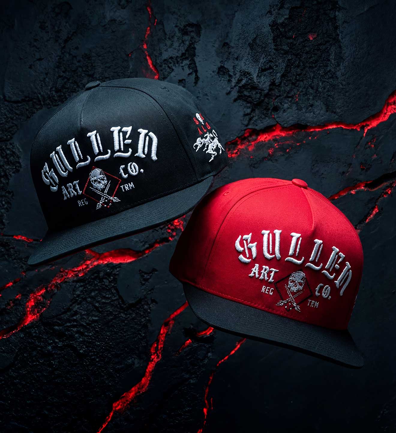 Two hats, one black and one red, with 'Sullied Art Co.' branding on a dark background.