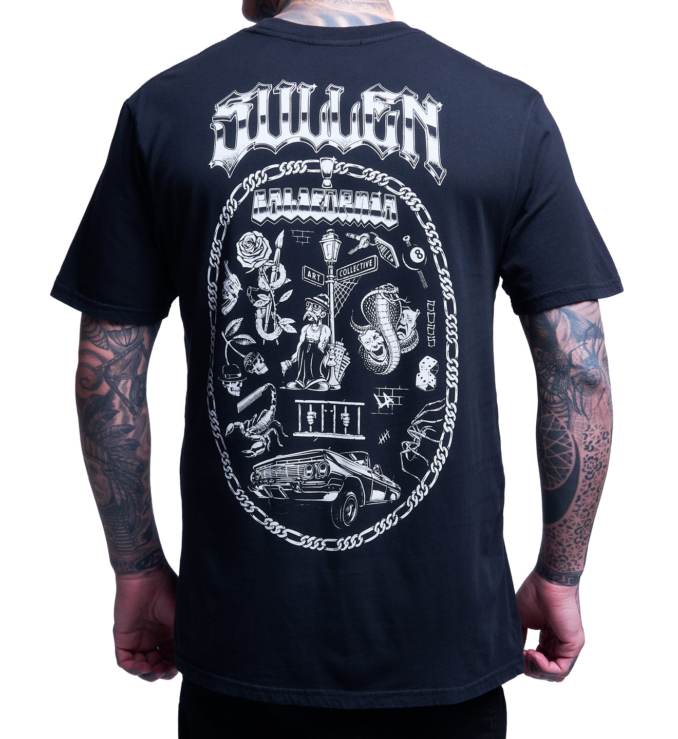 Black t-shirt with white graphic design on the back, worn by a person with tattoos.