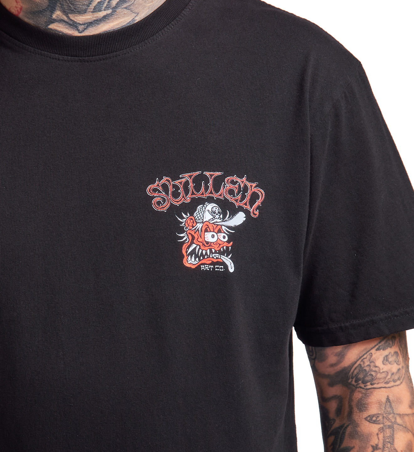 Black t-shirt with a graphic design on a person wearing tattoos.