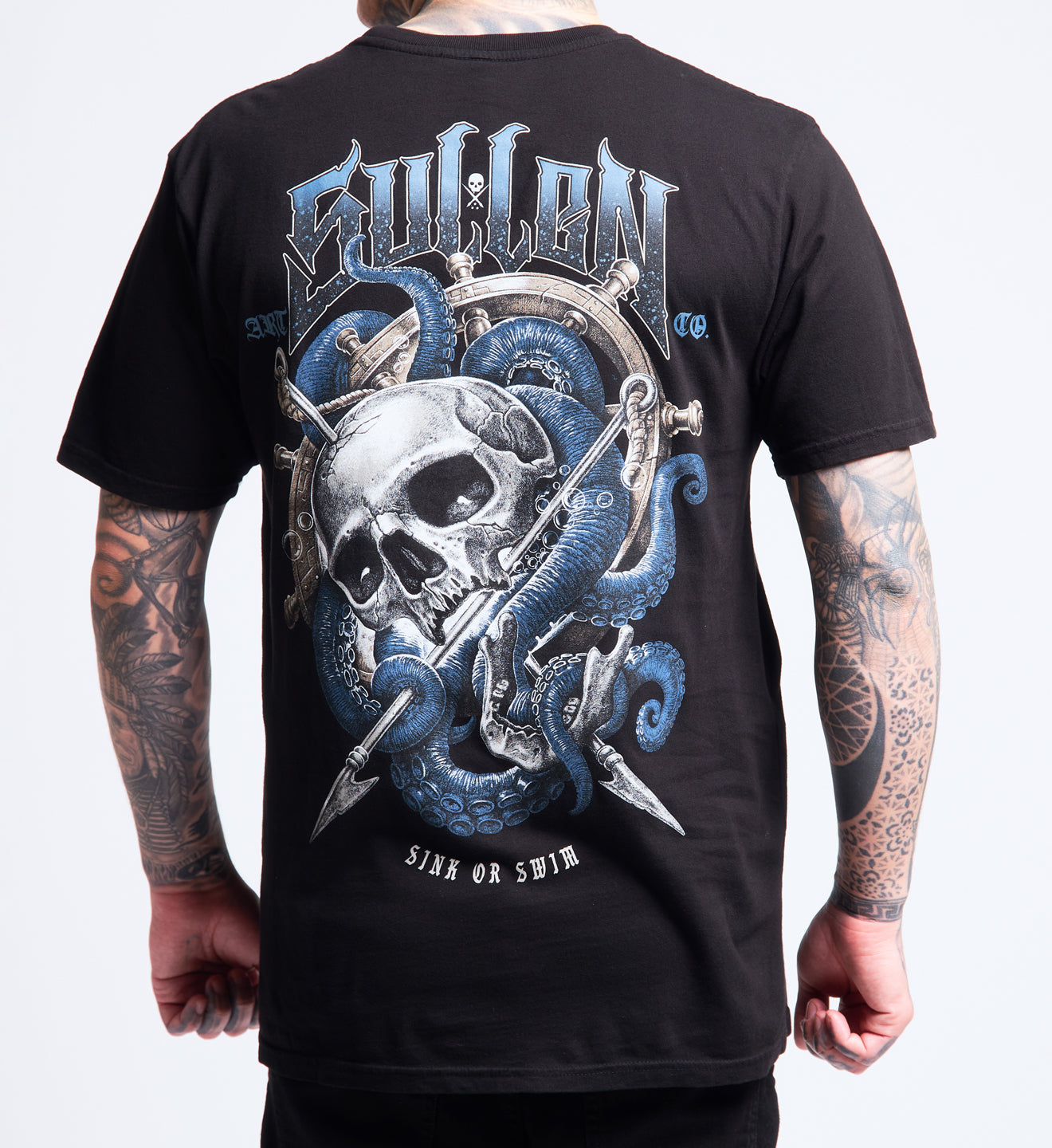 Black t-shirt with a skull and snake design on the back, worn by a person with tattoos.