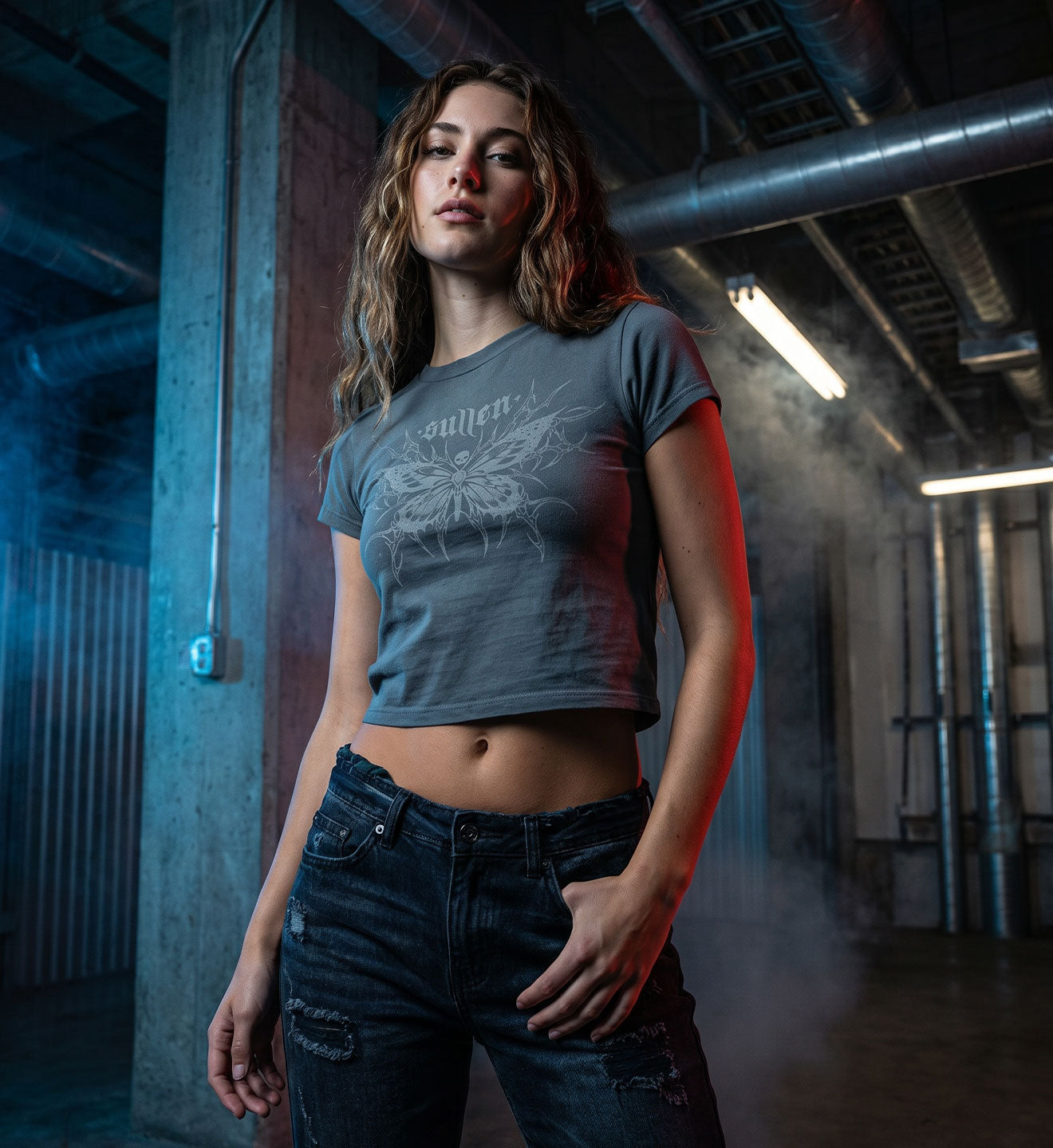 Woman wearing a graphic t-shirt and jeans in an industrial setting