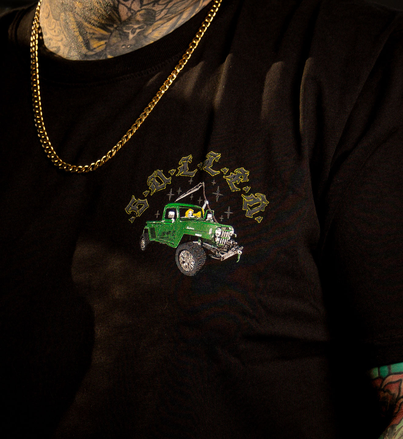 MODEL WEARING A BLACK SULLEN PREMIUM TEE WITH A REAPER DRIVING A JEEP GRAPHIC 