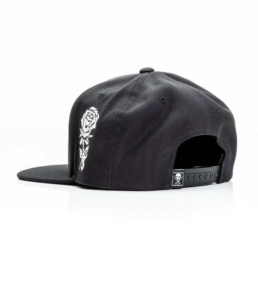 Black cap with white rose design on a white background