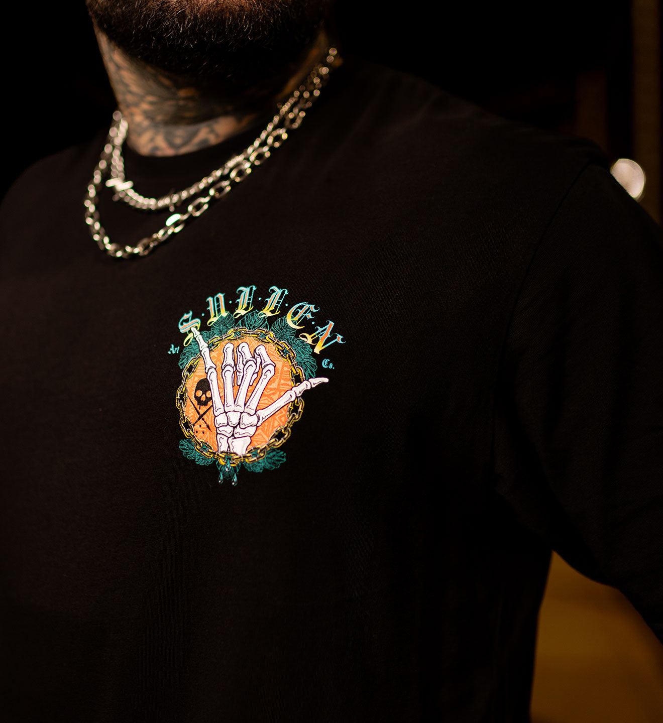 Black t-shirt with a colorful graphic design on a dark background