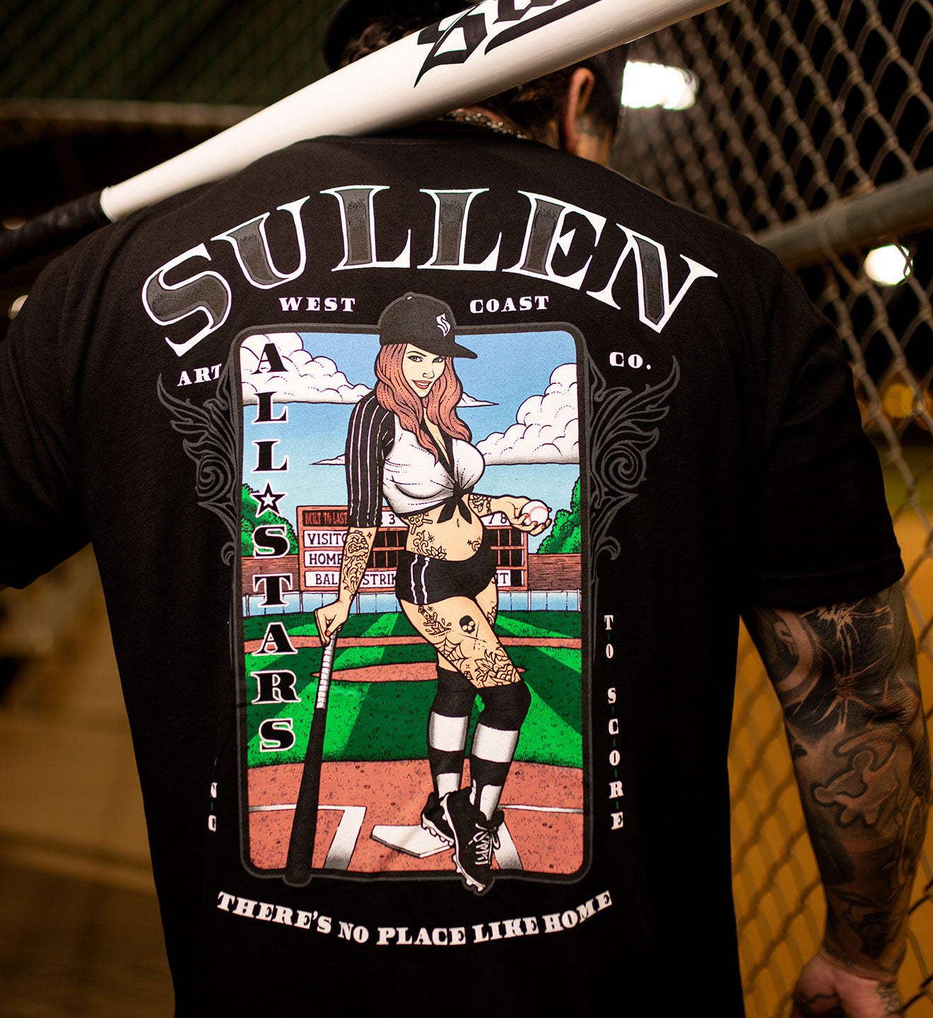 Person wearing a black t-shirt with a colorful graphic and 'Sullen' branding.