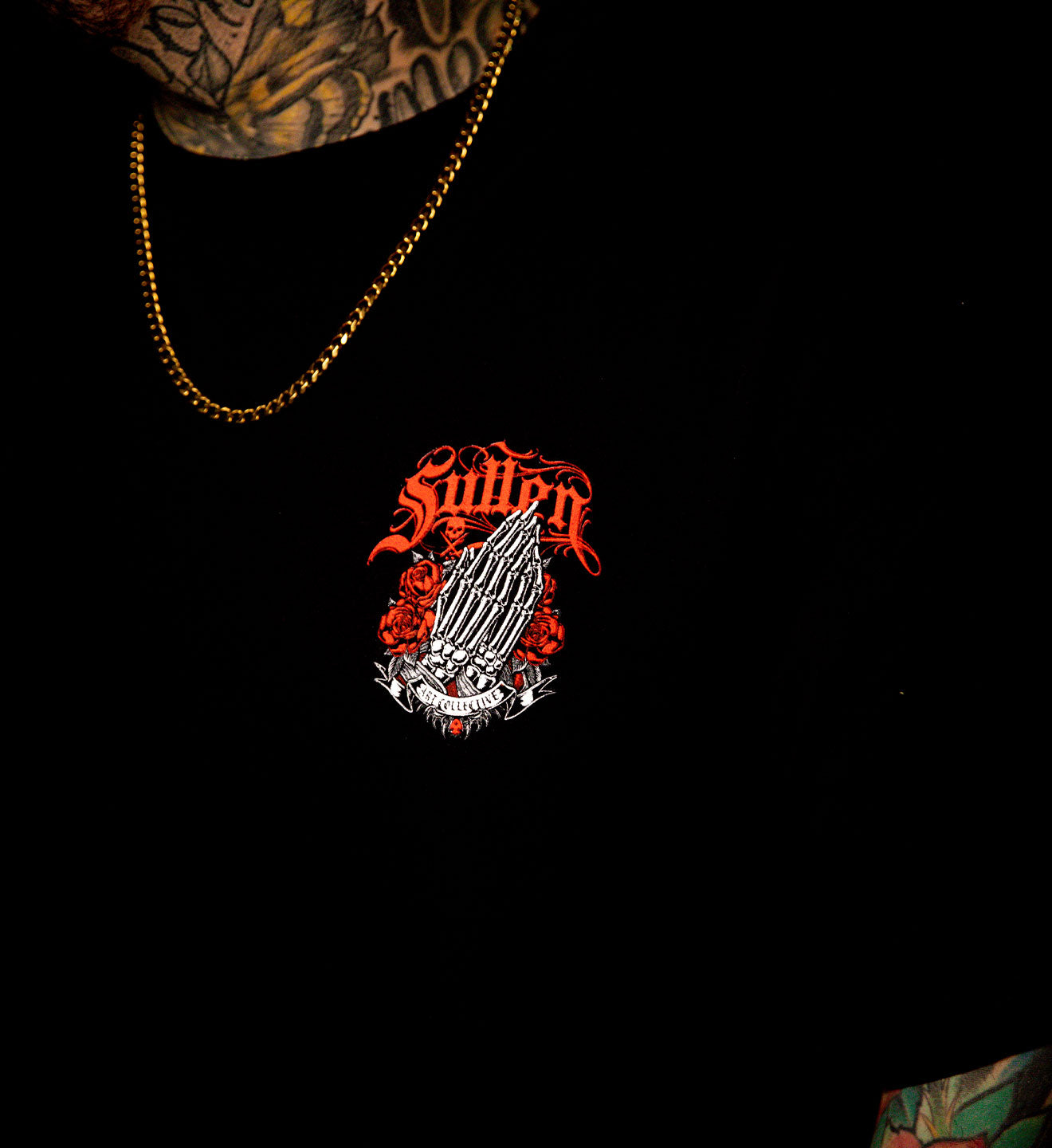 Black shirt with a red and white graphic design on a dark background
