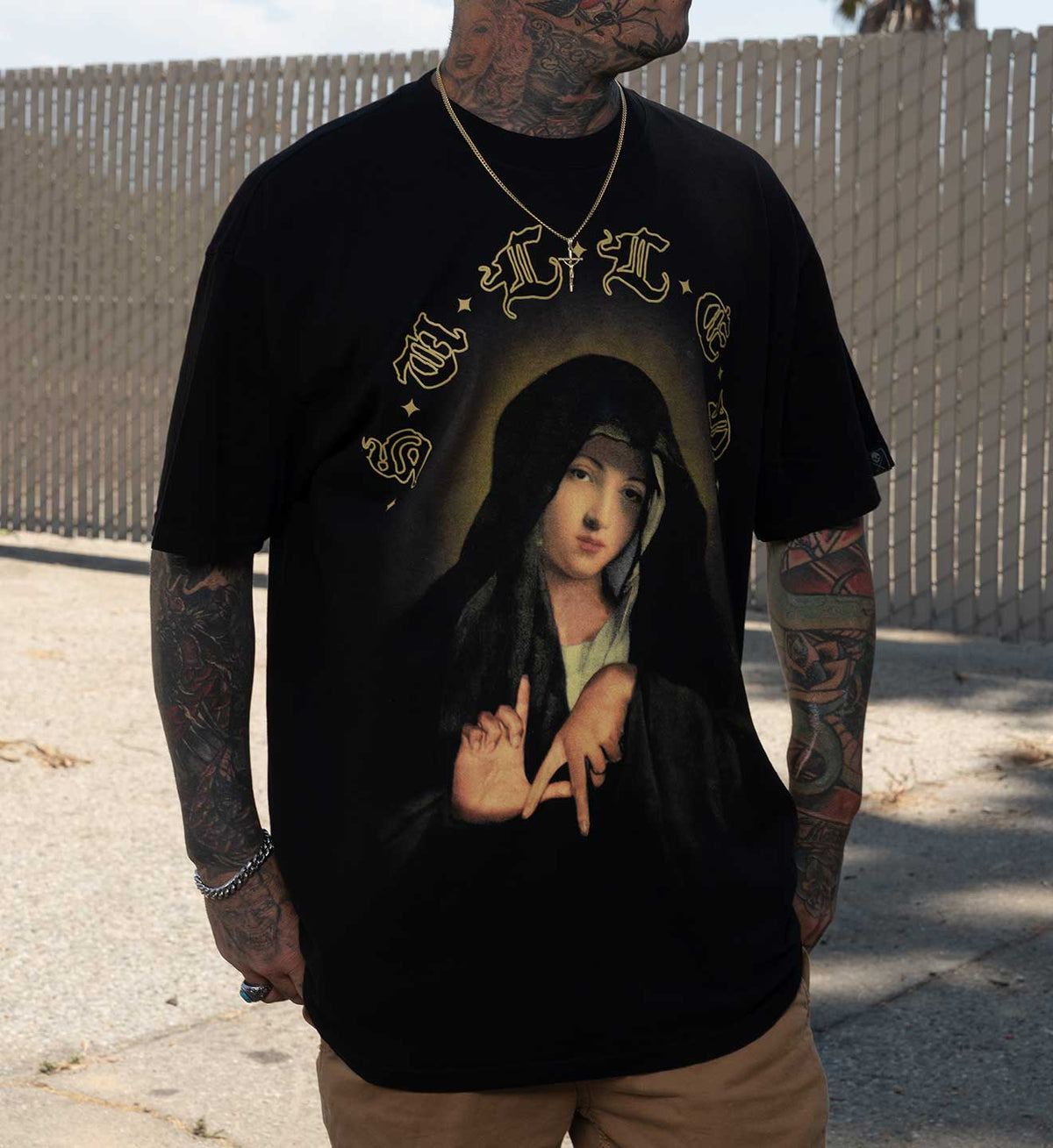 Sullen resurrection collection tee the Mary from aritist Ryan Smith. Black short sleeve tee worn by tattooed model
