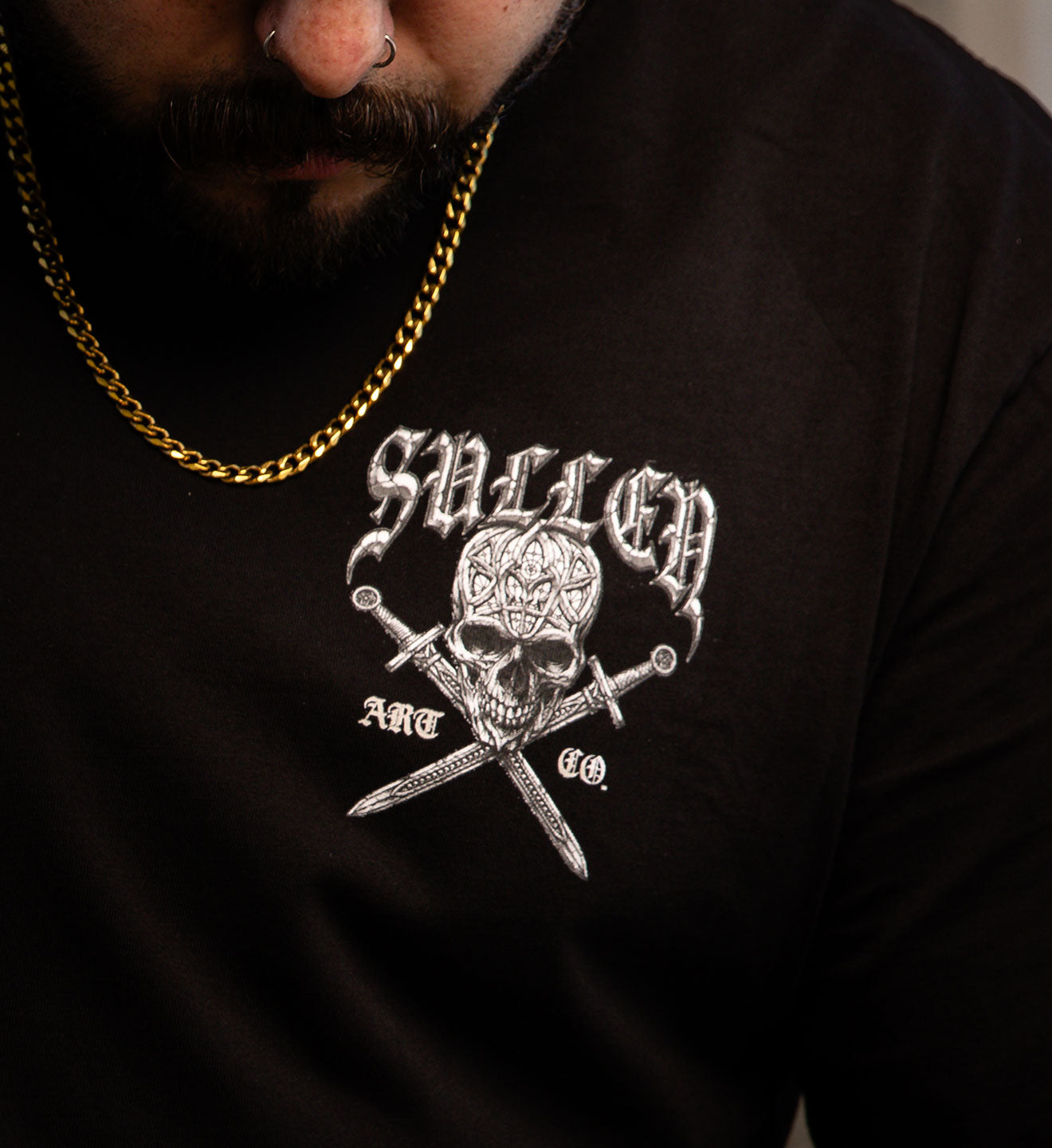 Black hoodie with a skull and crossbones design on a dark background