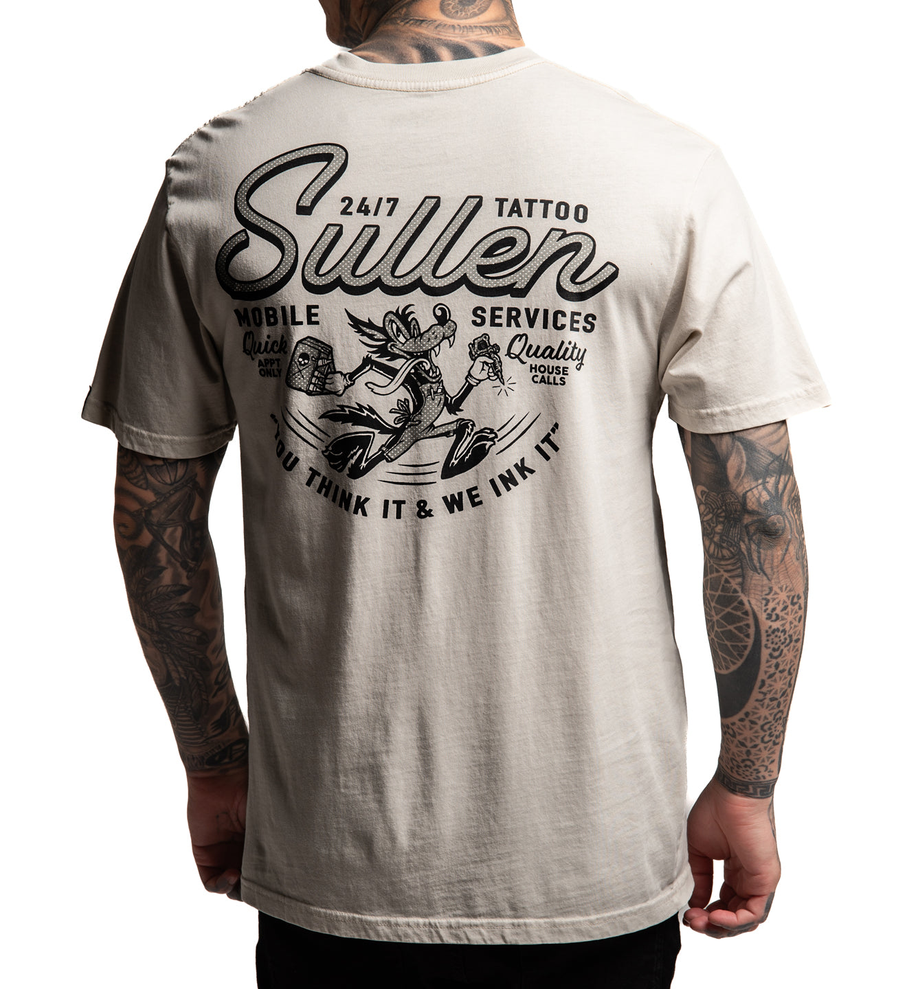 Person wearing a Sullen t-shirt with tattoo-themed design on a white background