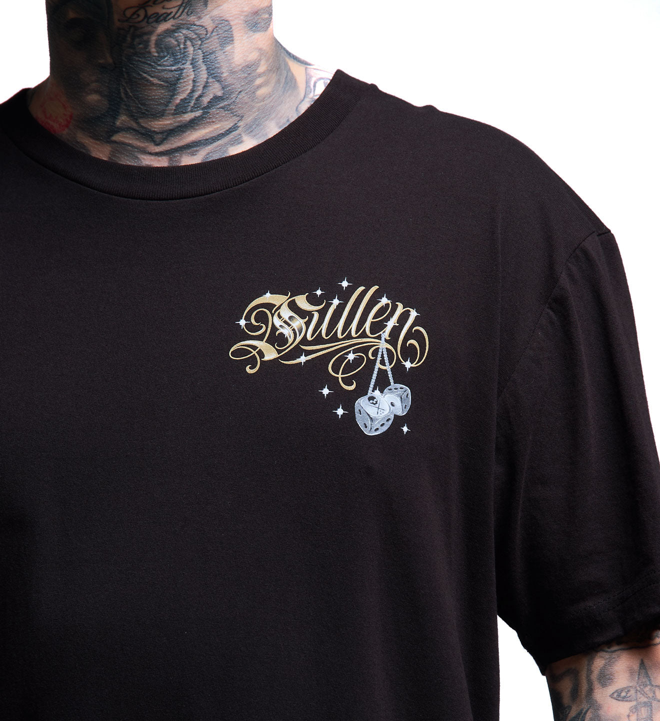 Black t-shirt with decorative text and design on a person wearing tattoos.