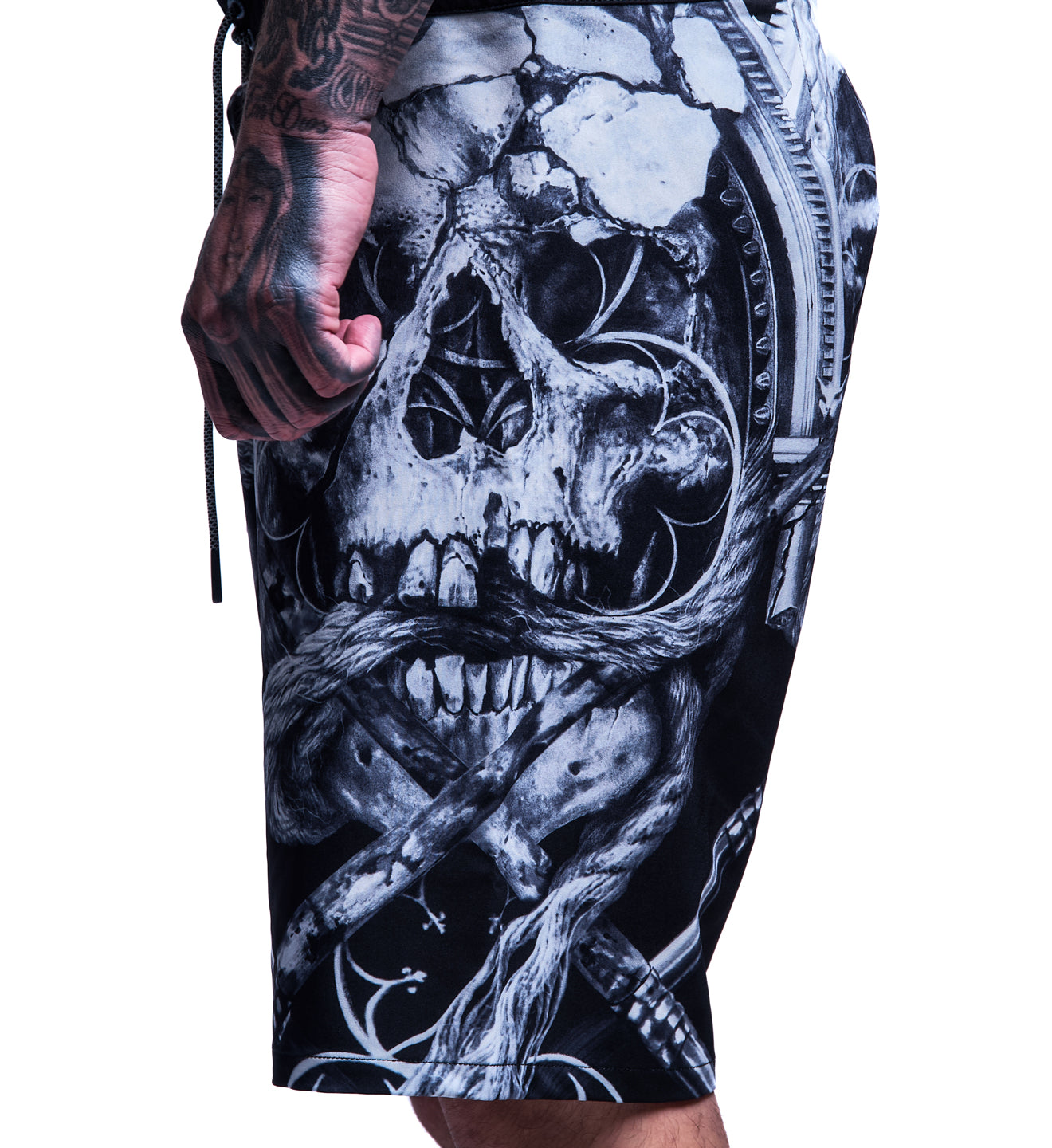 Black and white graphic design on a person's arm with tattoos.