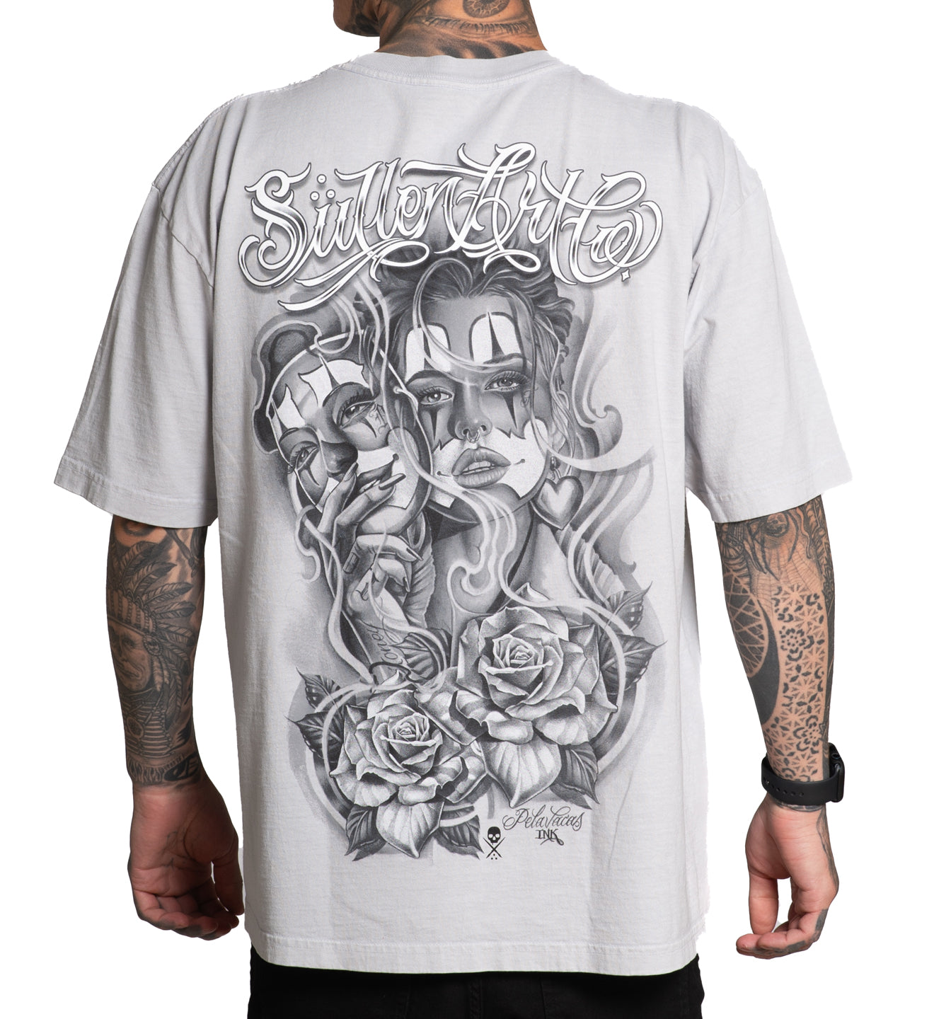White t-shirt with black and gray graphic design on a person wearing it.