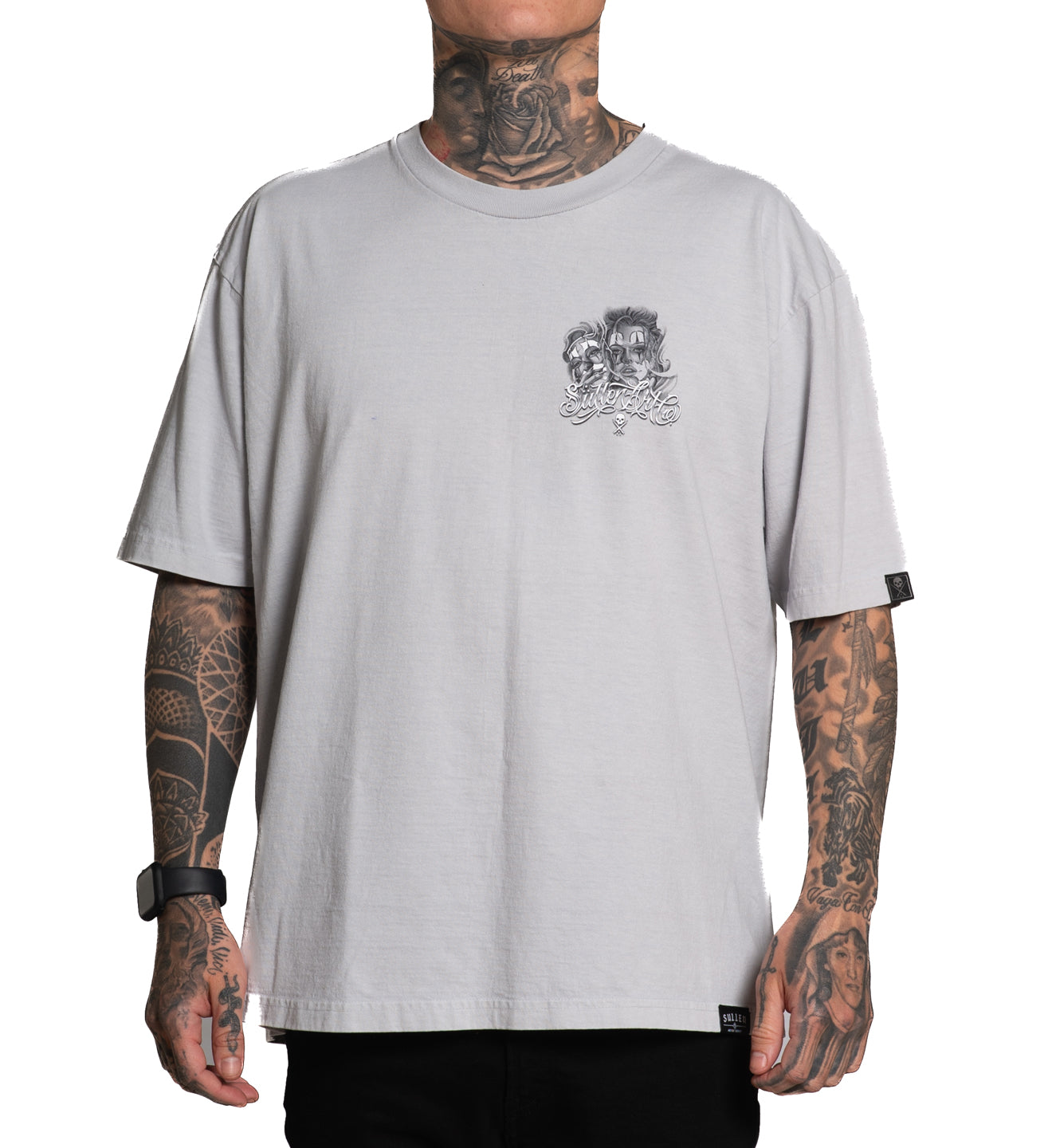 Person wearing a light gray t-shirt with a logo on a white background
