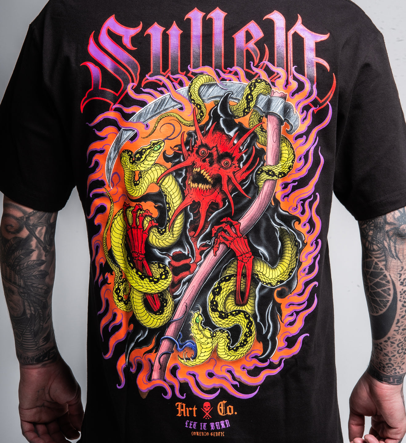 Black t-shirt with a colorful graphic design featuring two snakes and a scythe on a plain background.