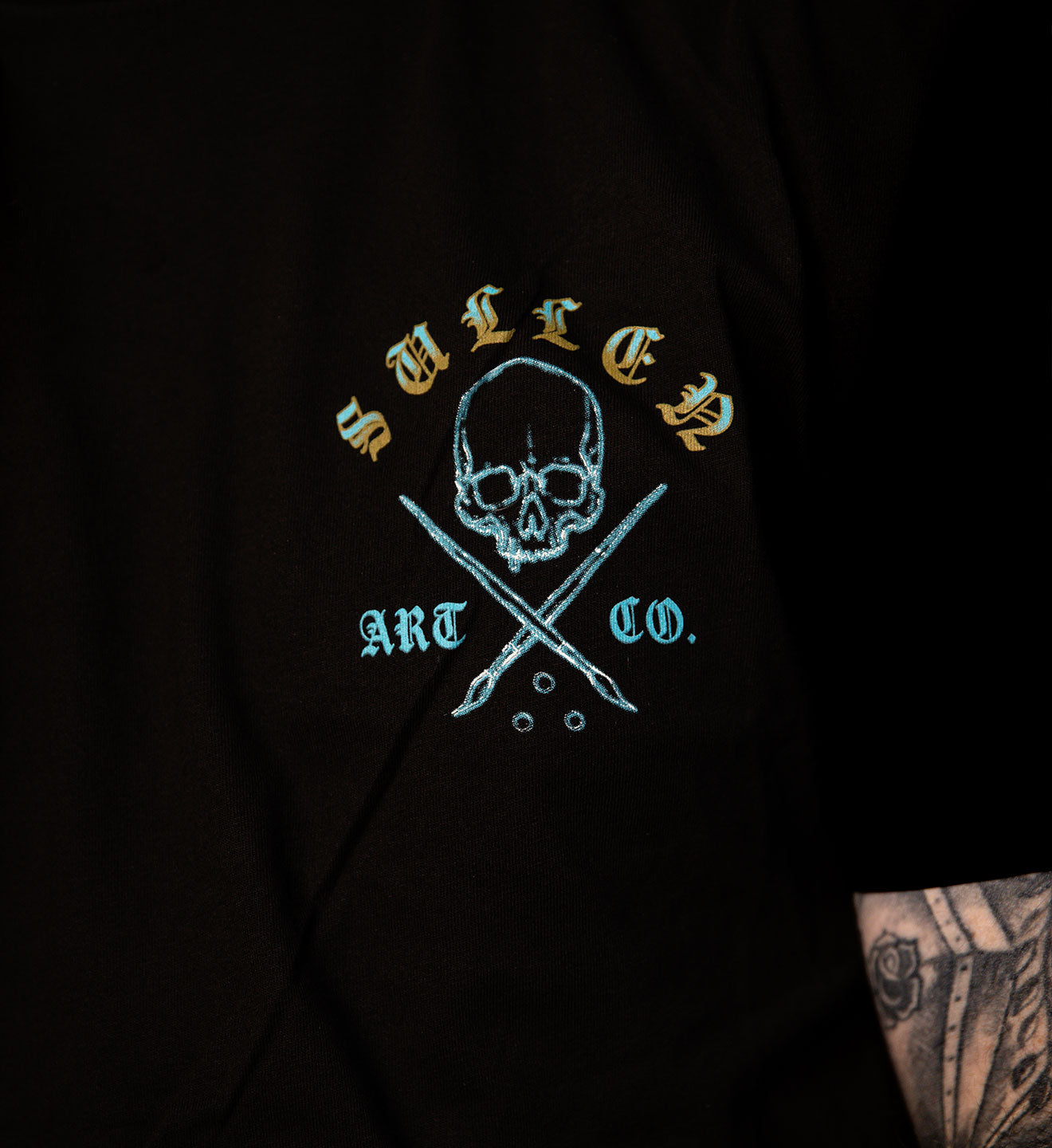 Black hoodie with 'Sullied Art Co.' logo featuring a skull and crossed tools on a dark background.