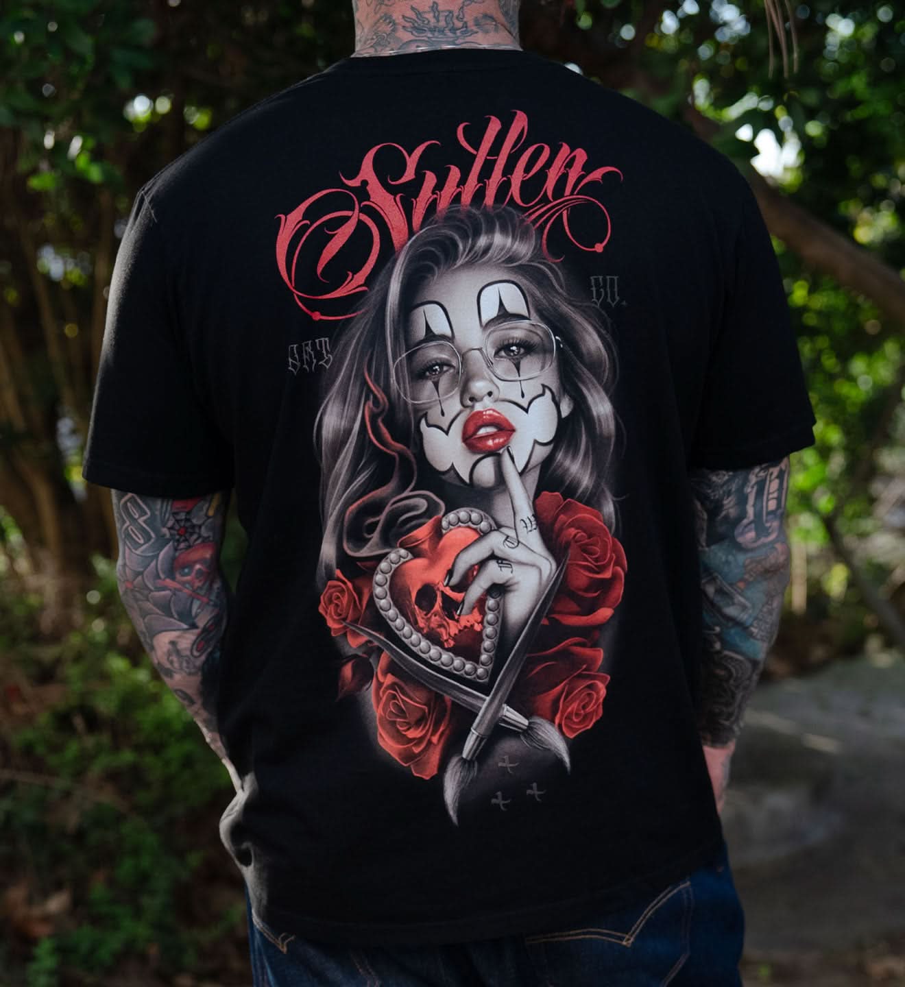 BLACK SULLEN T SHIRT WITH PORTRAIT OF WOMAN WEARING CHICANA MAKEUP AND A HUSH QUIET GESTURE