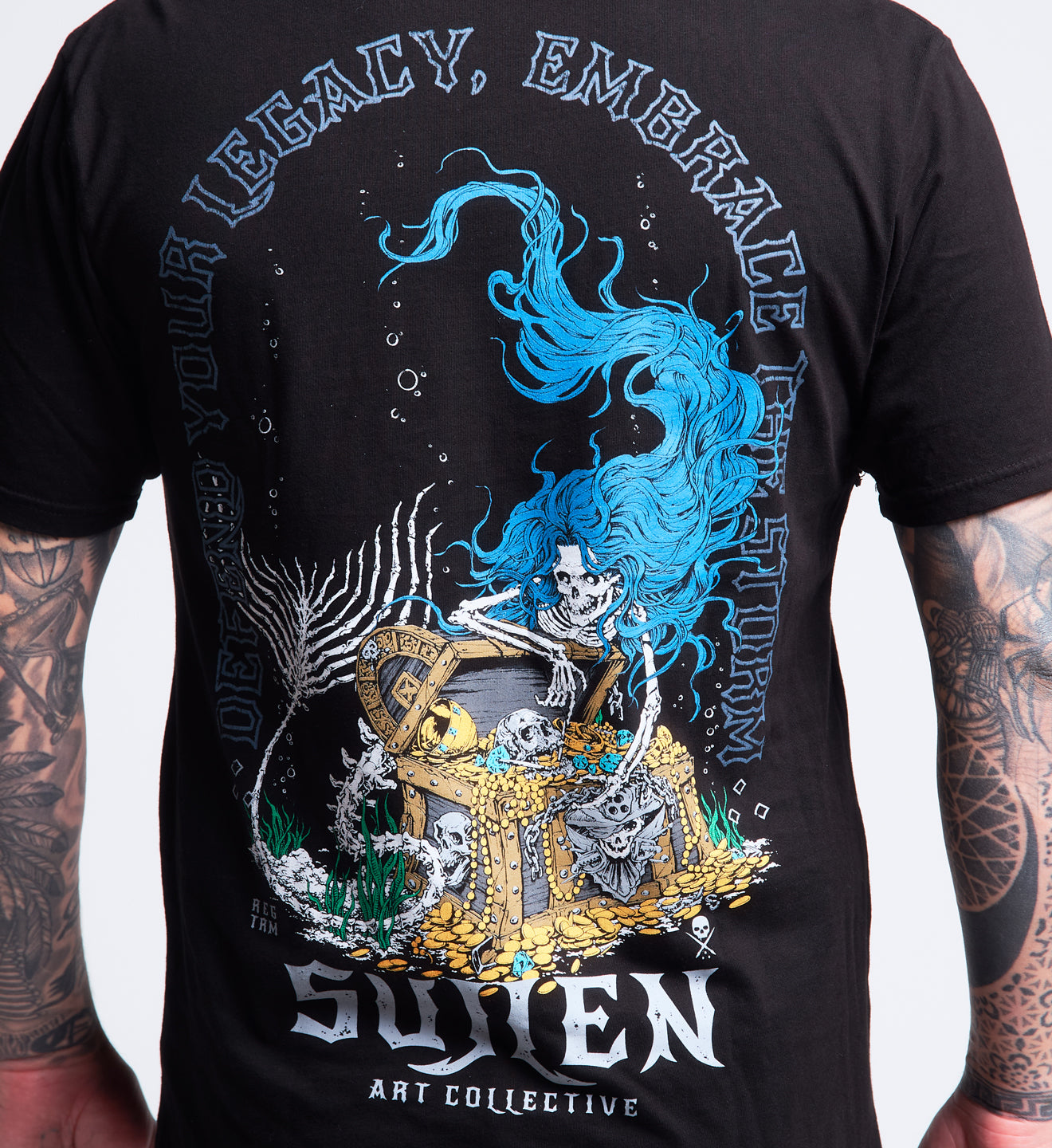 Black t-shirt with a colorful graphic design on the back, featuring a skeleton and text, with a person wearing the t-shirt.