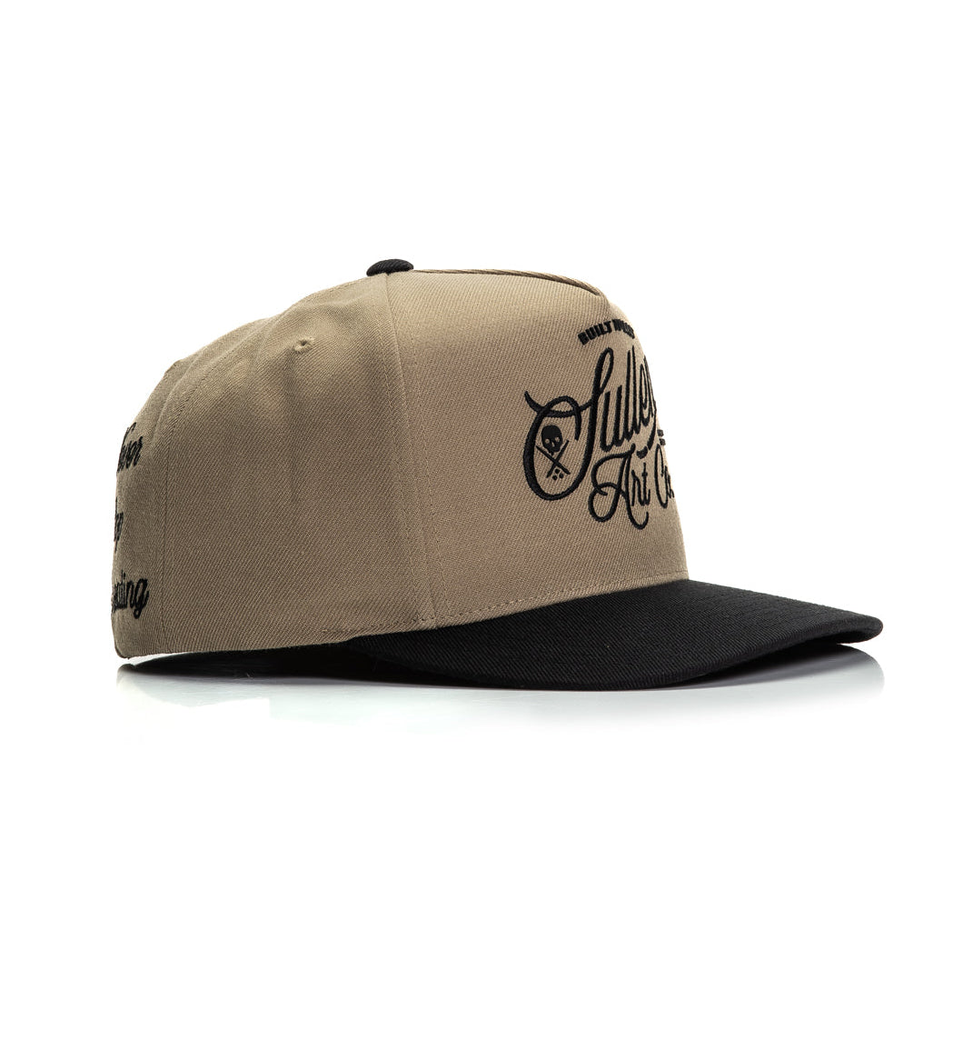 Beige and black cap with branding on a white background