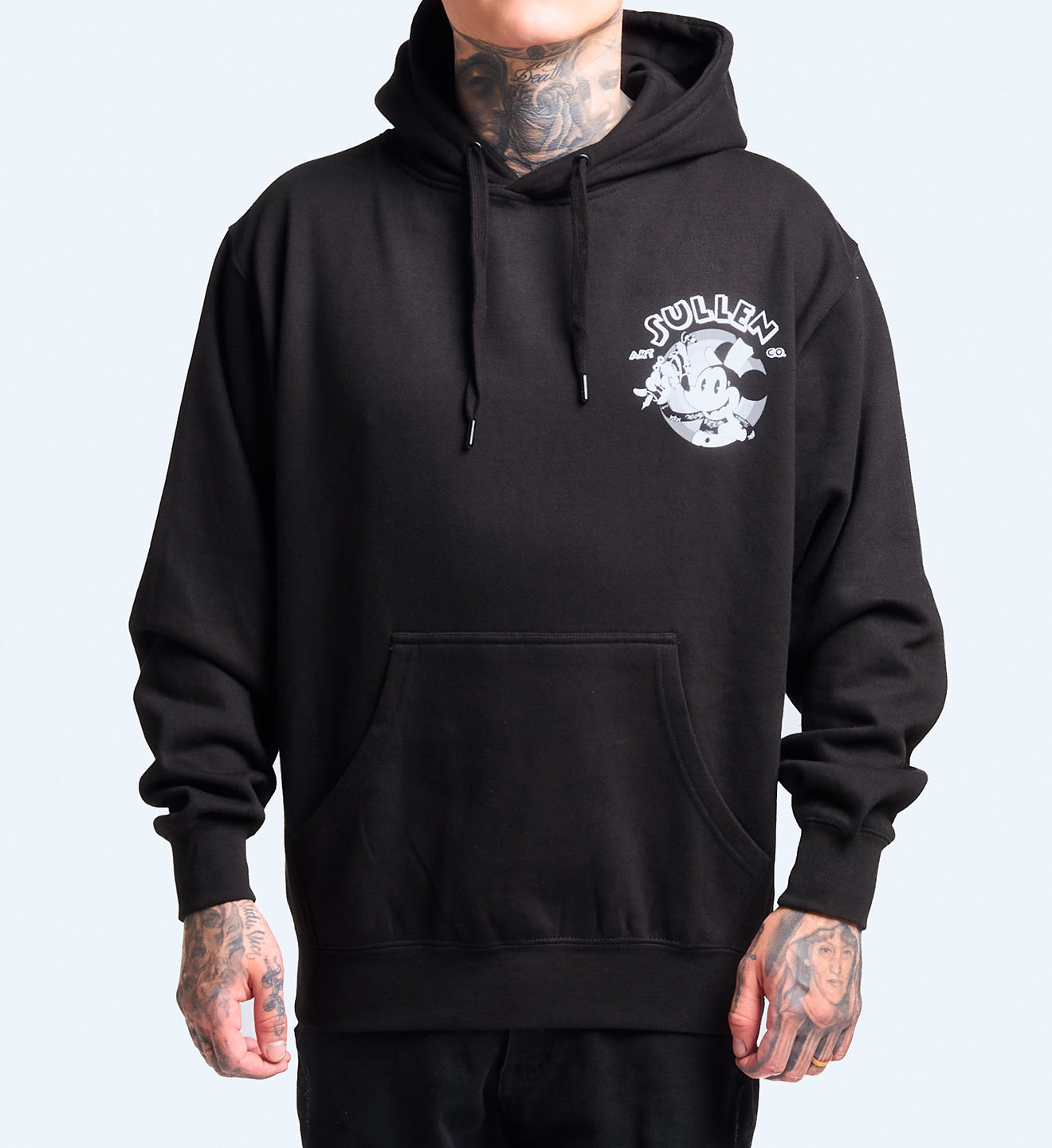 Person wearing a black hoodie with a logo on a plain background