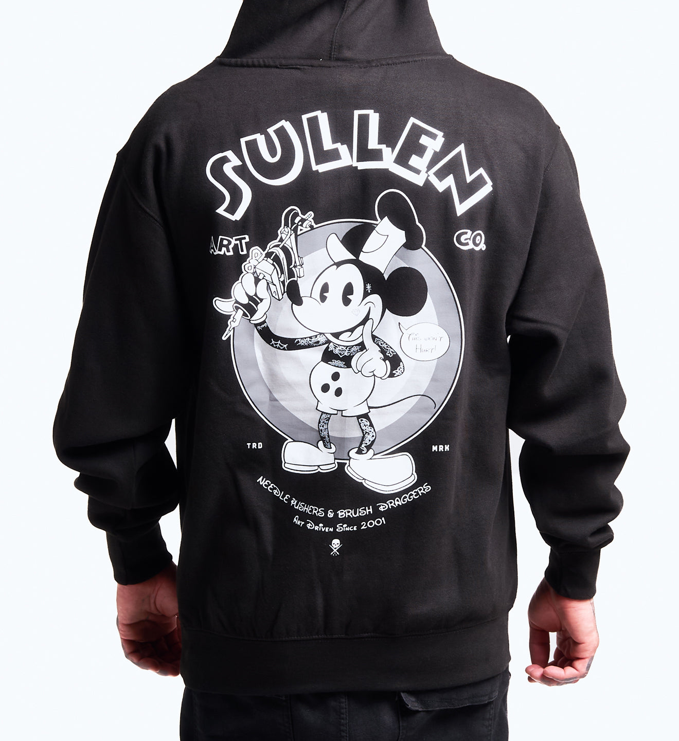 Black hoodie with a graphic design on the back featuring a character and 'Sullen' branding.