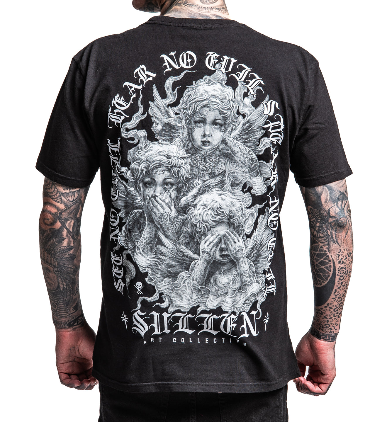 Black t-shirt with intricate design and text on the back, worn by a person with tattoos.