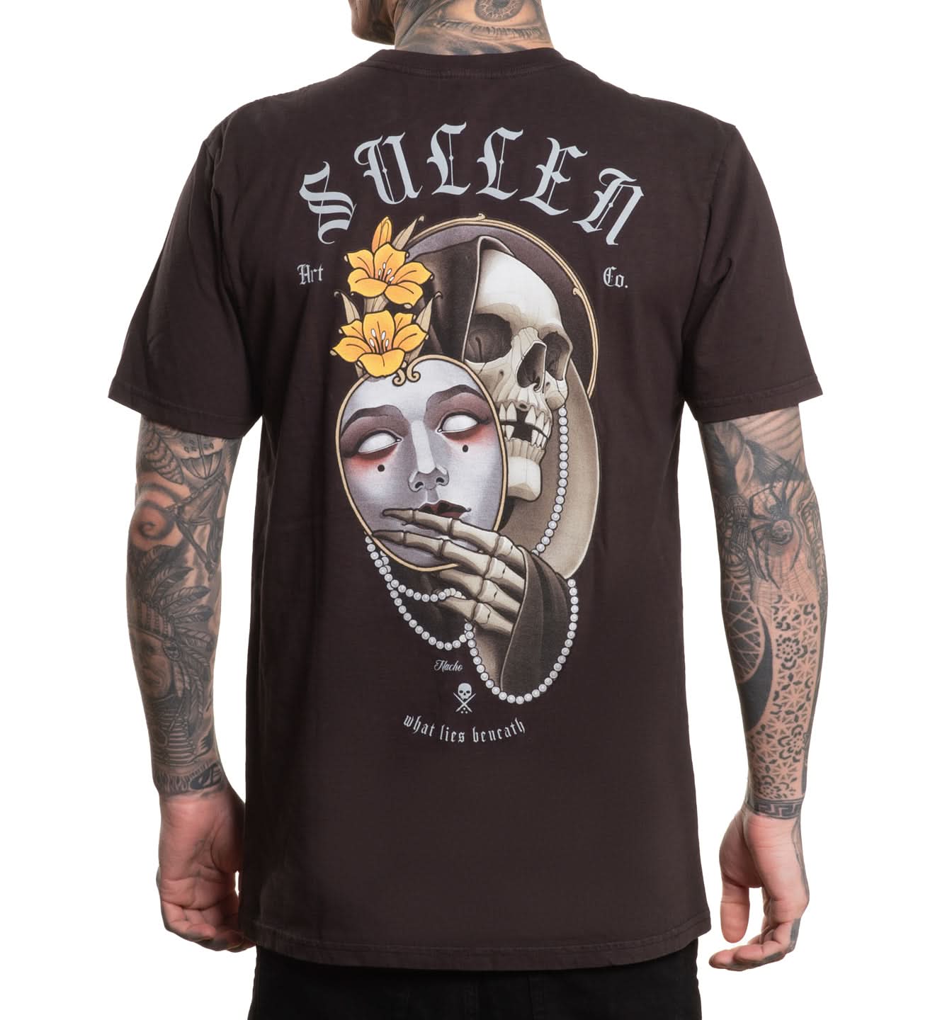 Person wearing a black t-shirt with a skull and floral design and 'Sullen' branding.