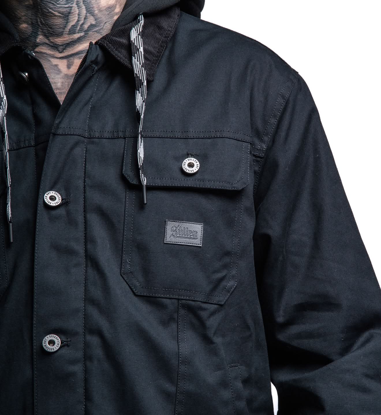 Close-up of a dark jacket with a brand logo on a white background