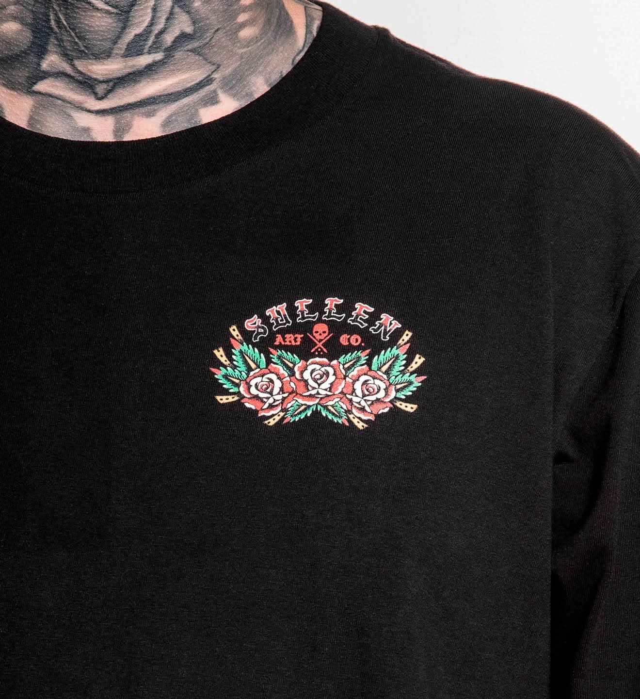 Black sweatshirt with embroidered design on chest, featuring text and floral elements.