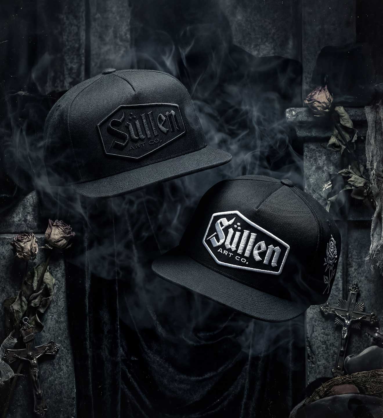 Two black caps with 'Sullen' logo on a dark, smoky background