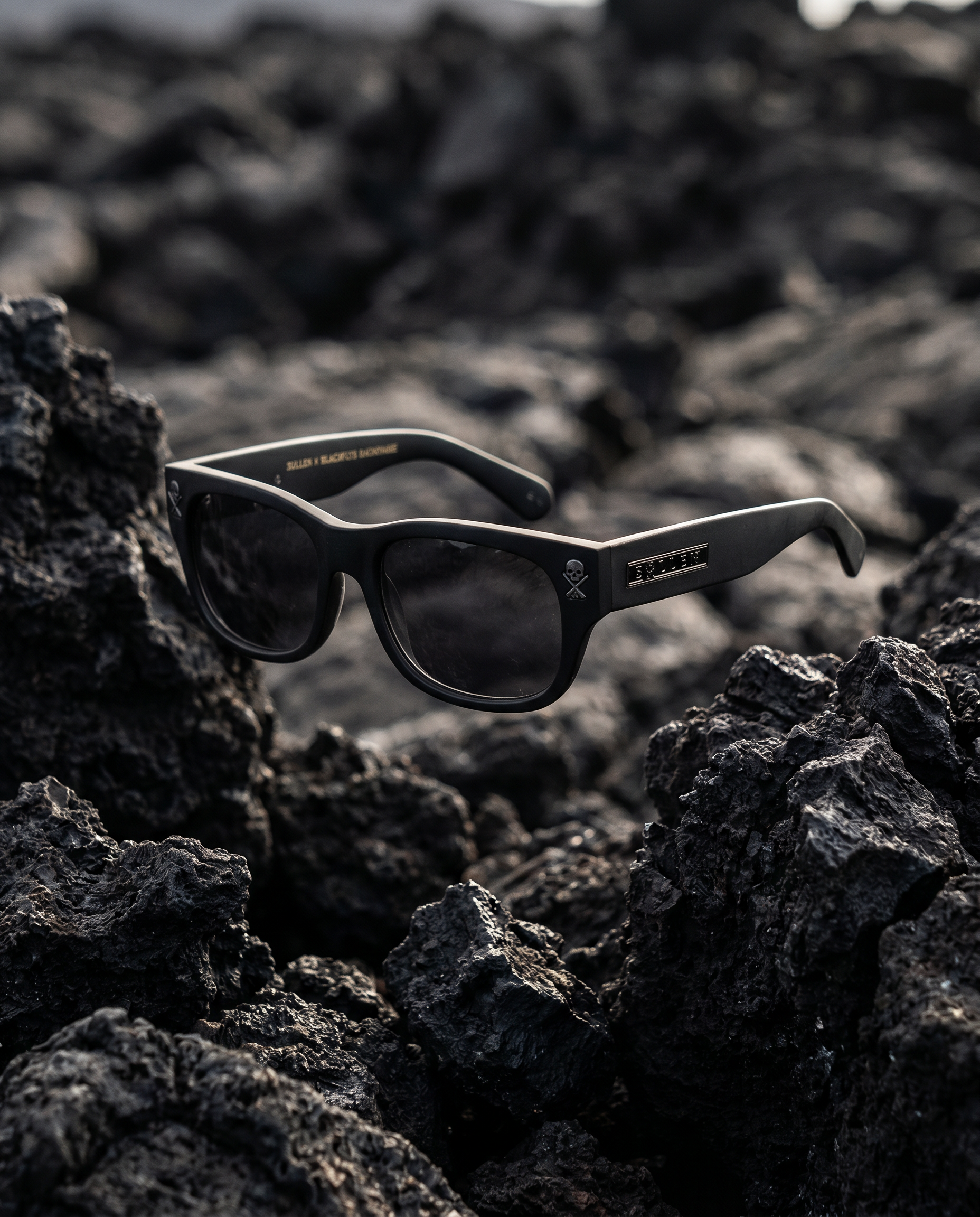 sunglasses floating over lava rock