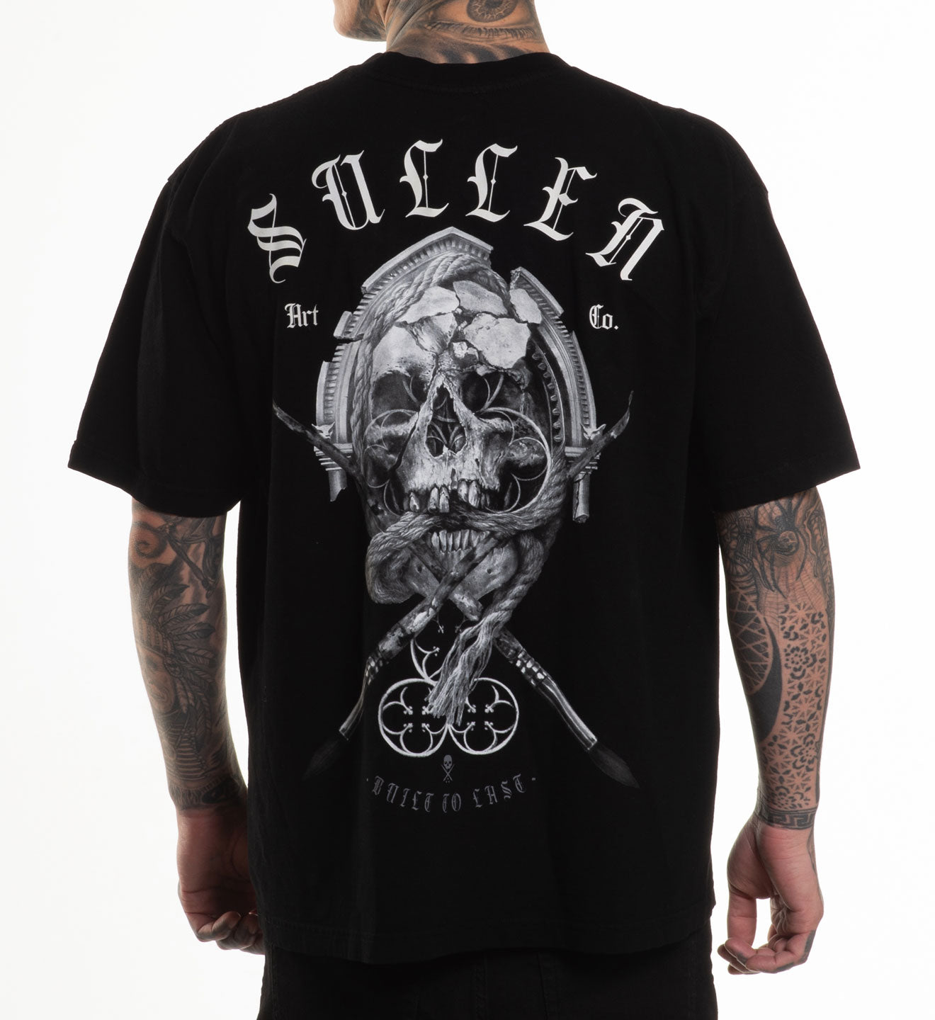 Black t-shirt with skull and crossbones design and 'Sullen' branding on a white background