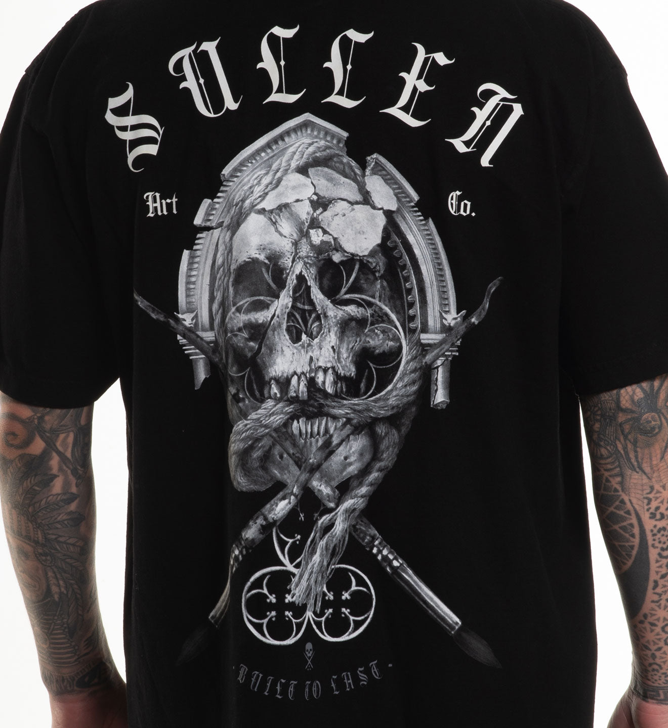 Black t-shirt with a detailed skull design and 'Sullen' branding on the back.