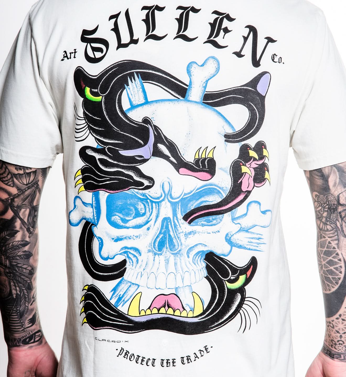 White t-shirt with a colorful skull design and 'Sullen' branding.