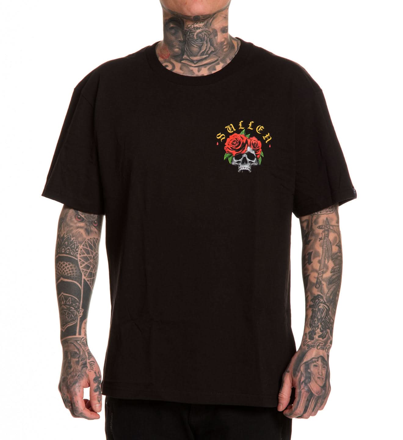Person wearing a black t-shirt with a logo featuring roses and a skull, on a white background.