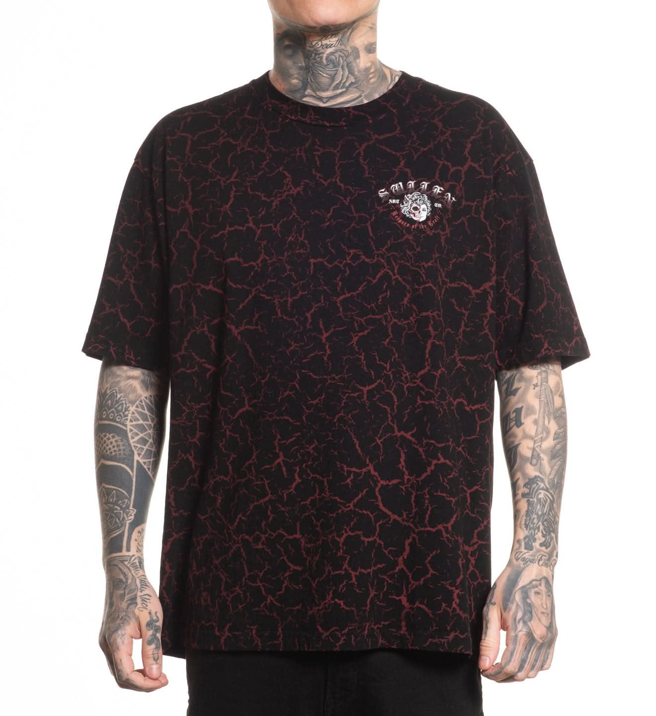 Black t-shirt with red pattern worn by a person with tattoos on a white background